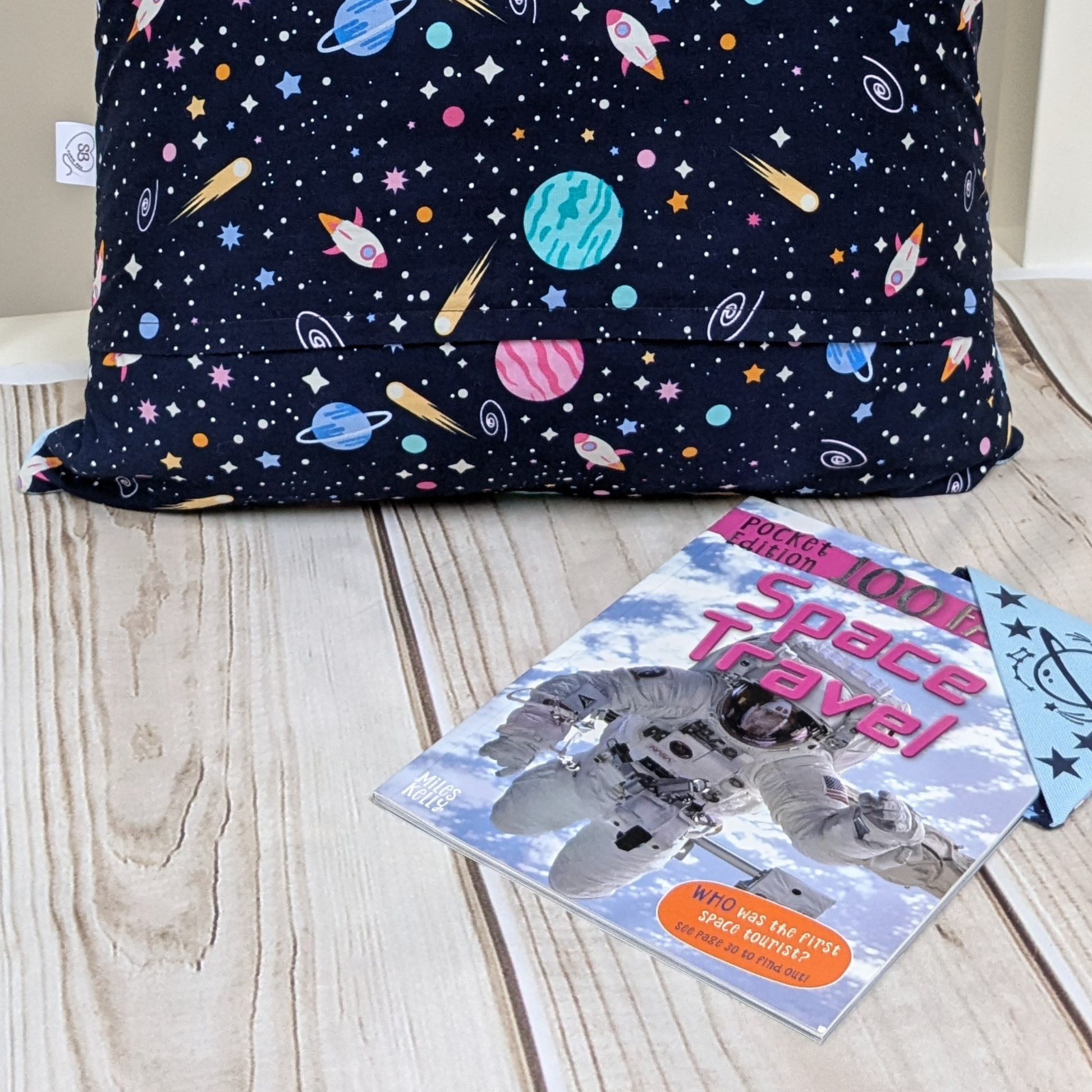 Space themed reading pocket cushion with slogan Reading isout of this World. With Bookmark & Space Travel Book. Pocket with slogan.