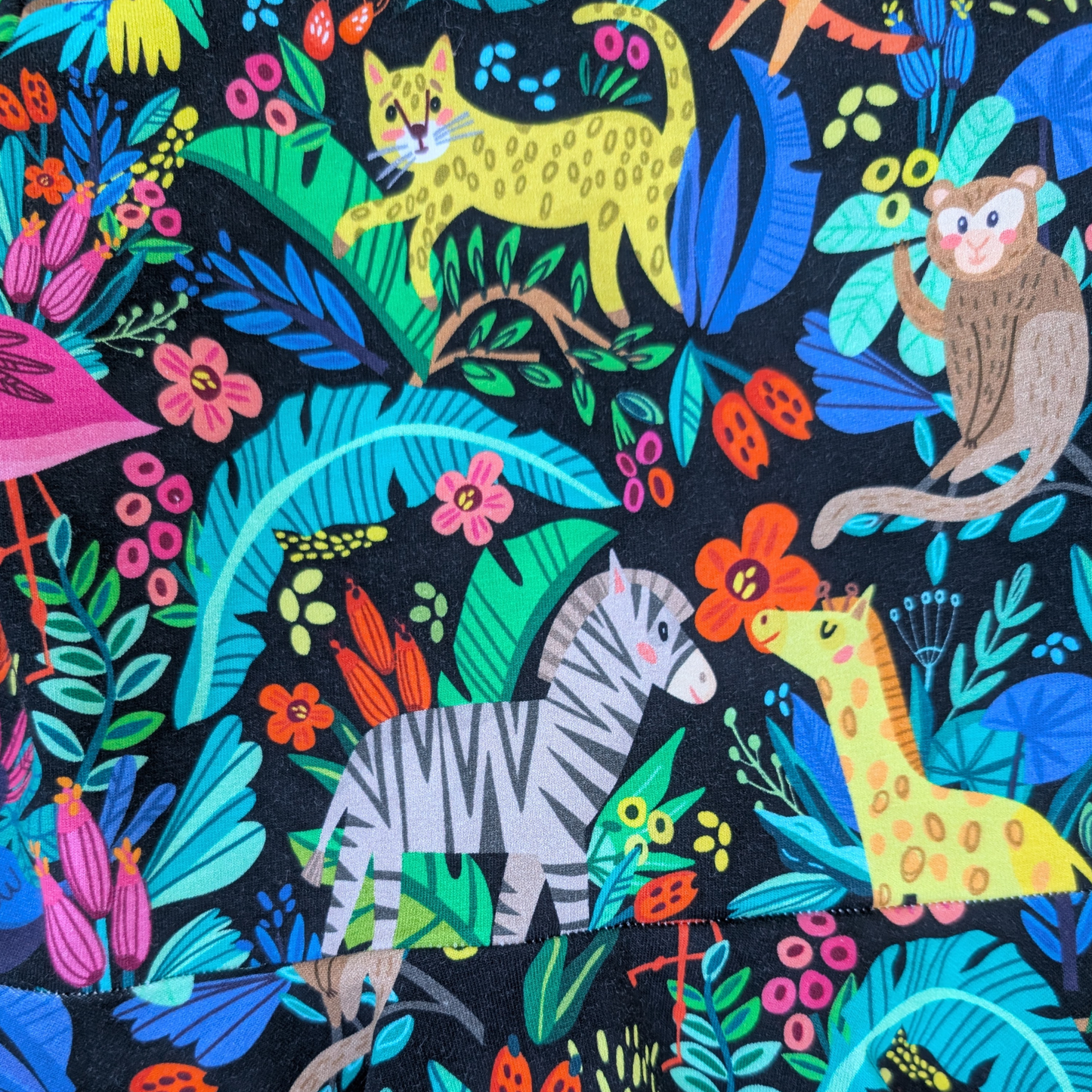 Close-up-Pattern-cheetahs-monkeys-giraffe-zebra-flowers-Bright-fun-jungle-flatlay-dress-pink-cuffs-neck