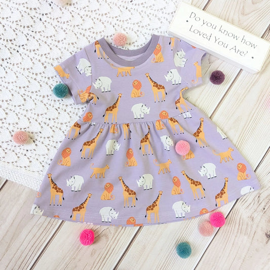 Children's dress with animal pattern on a wooden surface